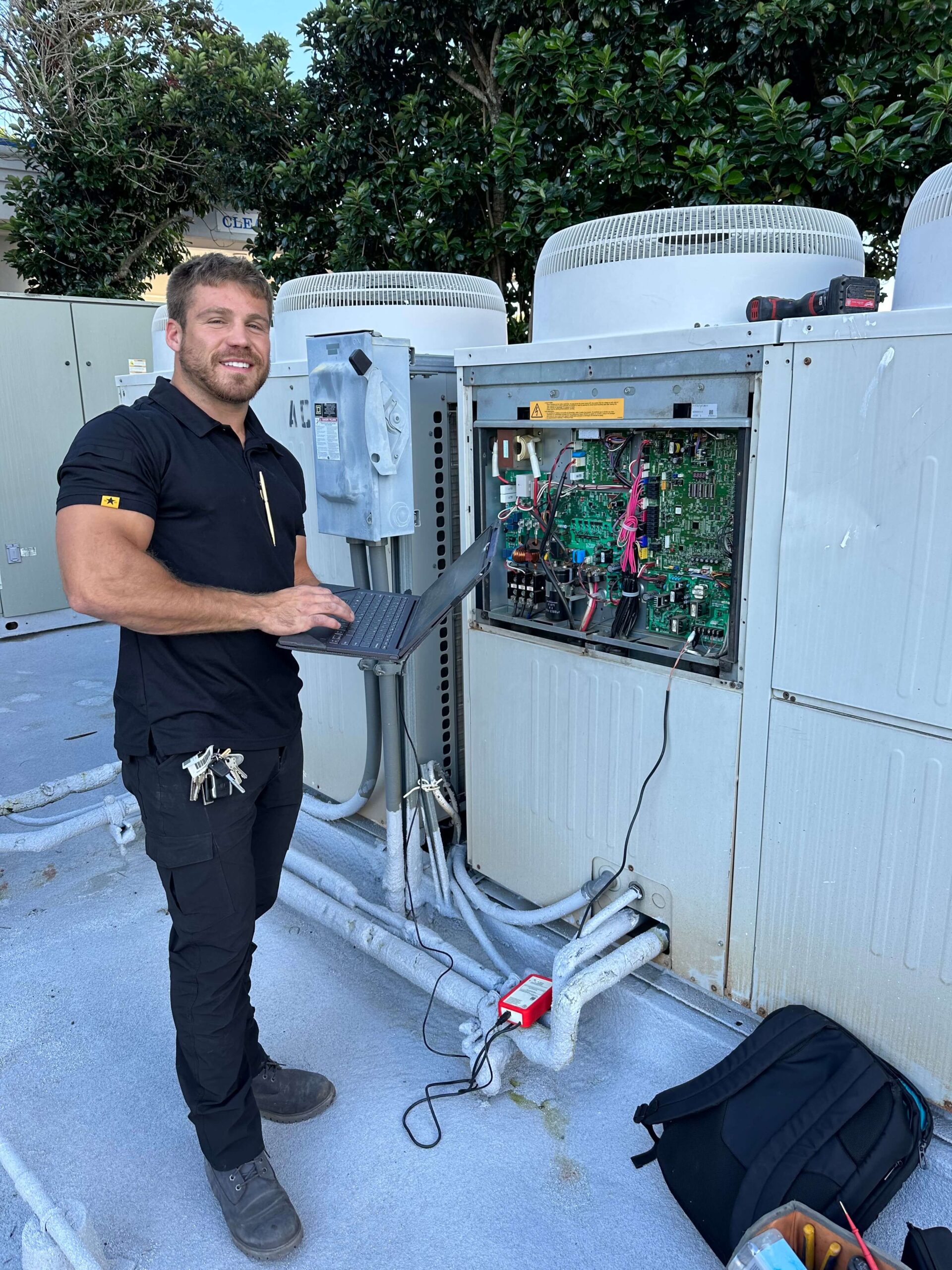 technician next to an HVAC system