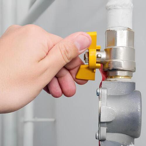 turning a gas valve on a pipe
